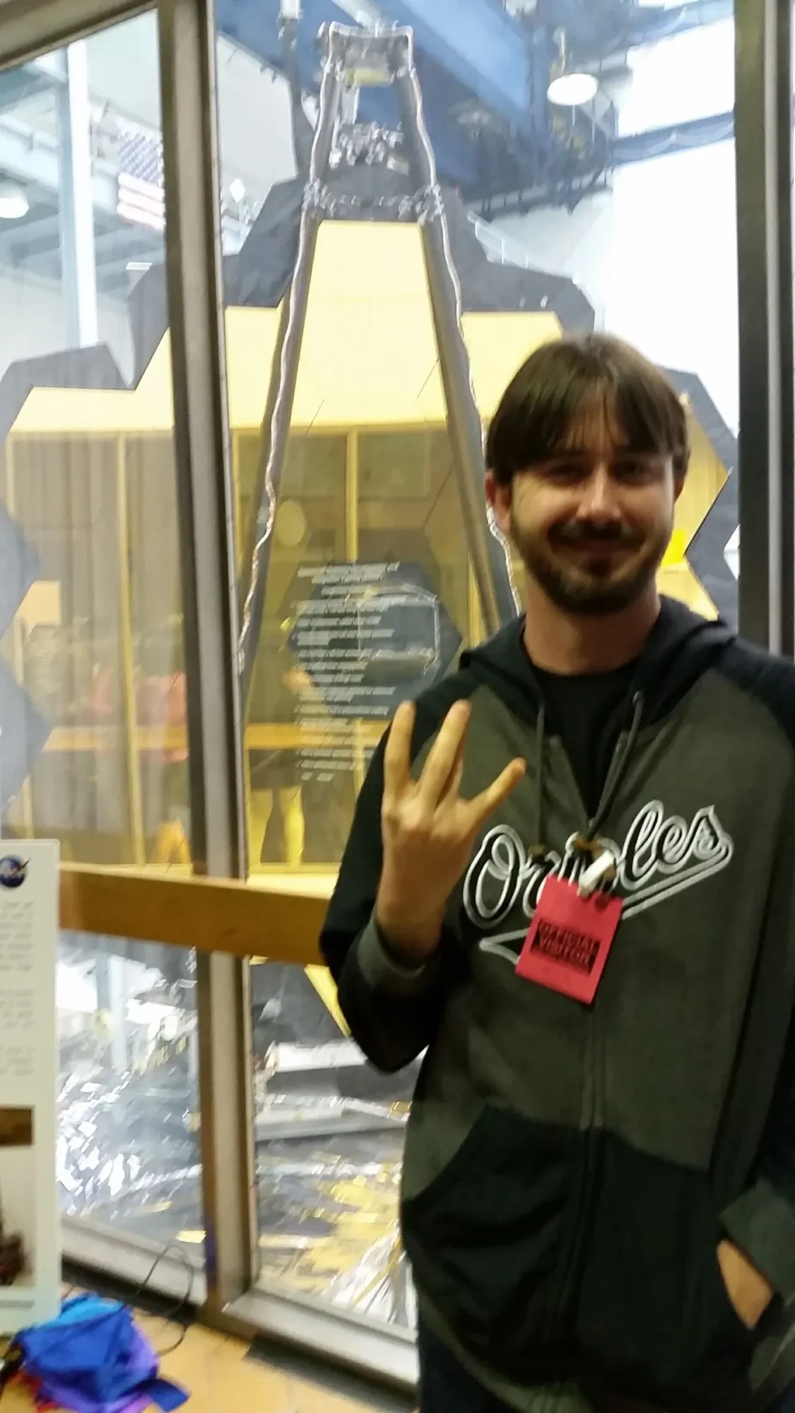 Chris Moriarty beside the James Webb Space Telescope's mirror at Goddard